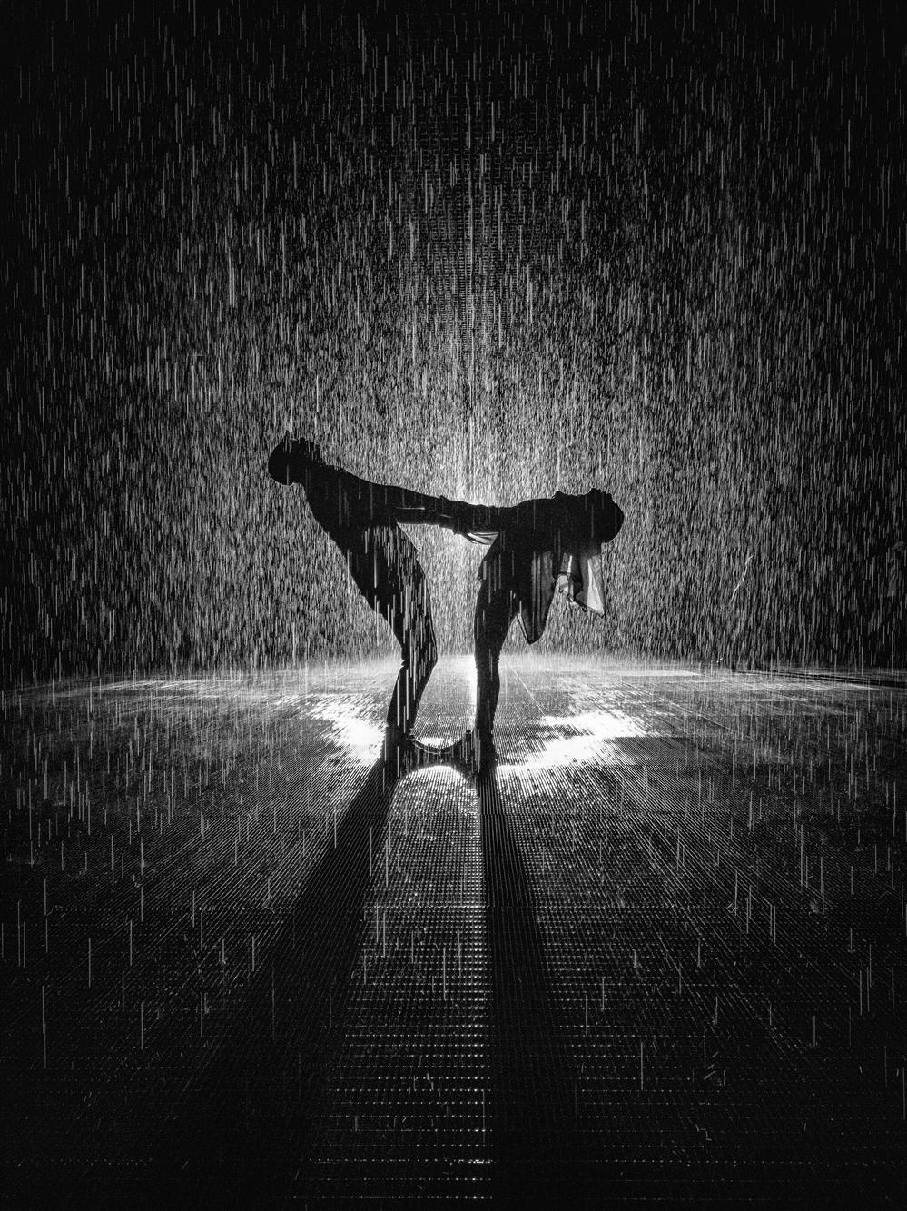 A couple sharing moment under a water droplets.